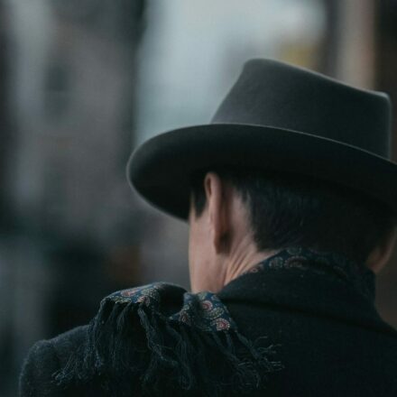 Detective walking away from frame down an empty street